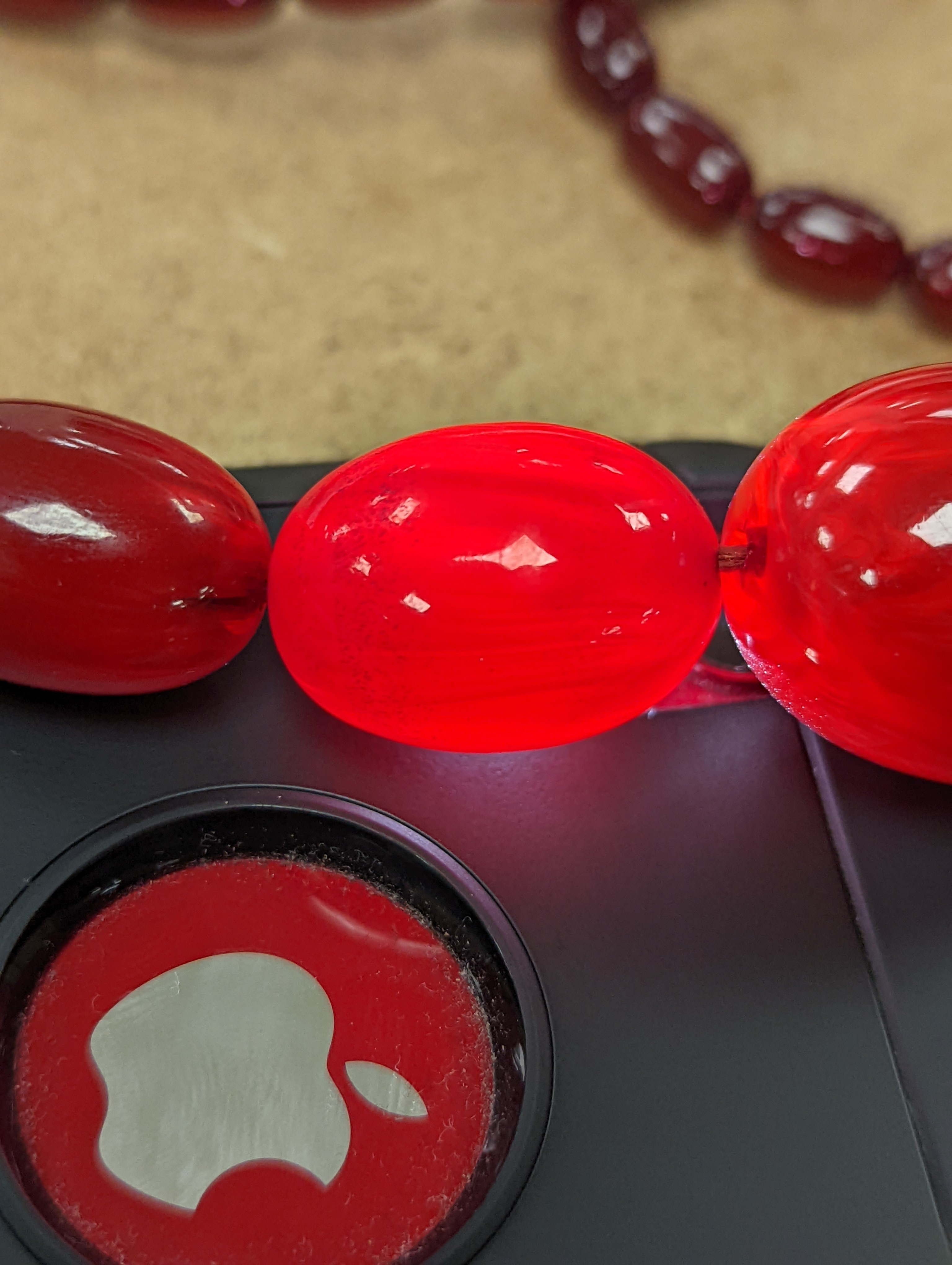 A single strand graduated simulated cherry amber bead necklece, 72cm, gross weight 63 grams.